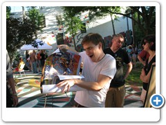 Mural artist Billy Mitchell with his poster of the mural.